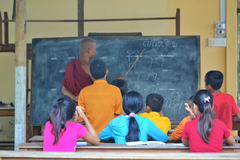 there is a woman teaching a class on a blackboard