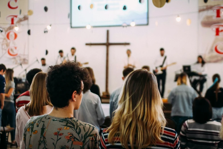 people standing in front of an open church looking at the choir