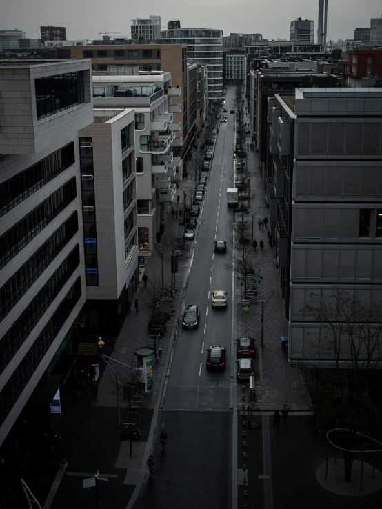 an overcast city view looking down the middle of a city street