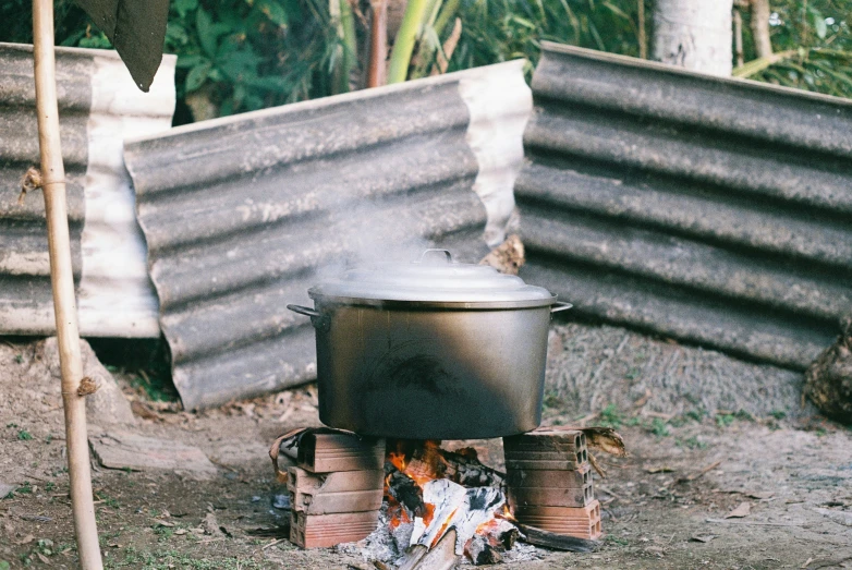 an outdoor stove with logs and some other items