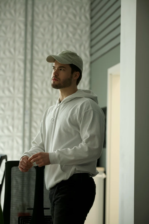 a man in a hat standing in a room