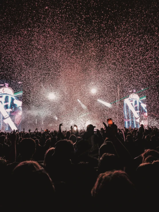 a stage with two microphones and a huge crowd in front