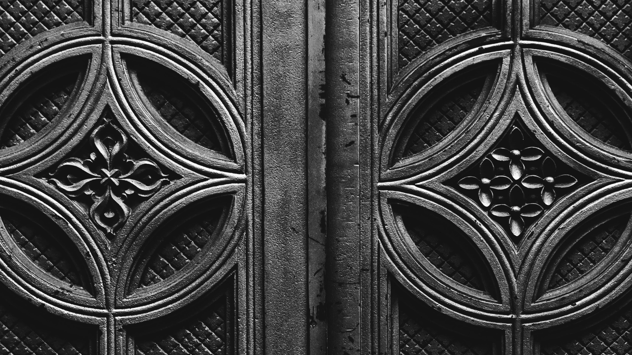 close up of the designs on a door with black background