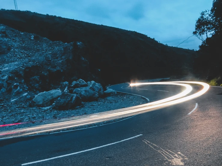 a night s of a road with cars going around it