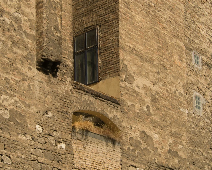 a window in an old, brick building