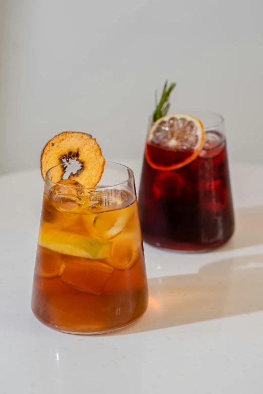 some drinks sitting on a table and one is filled with drinks