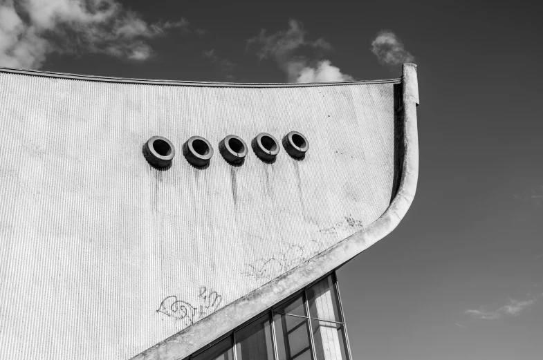 the side of a building with three clocks at night