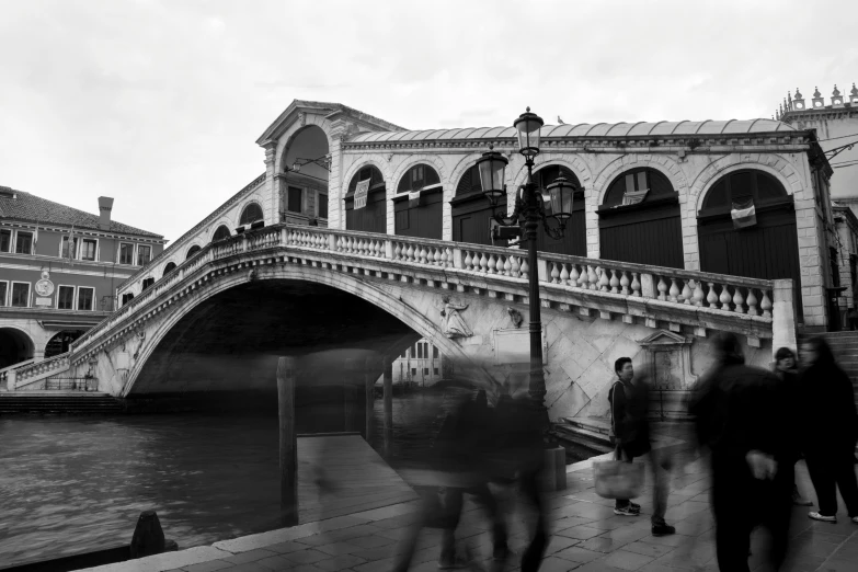 a boat in the water passing by a bridge