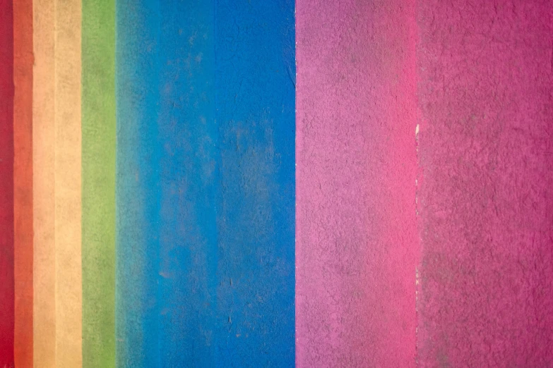 a rainbow background with different colors of paint