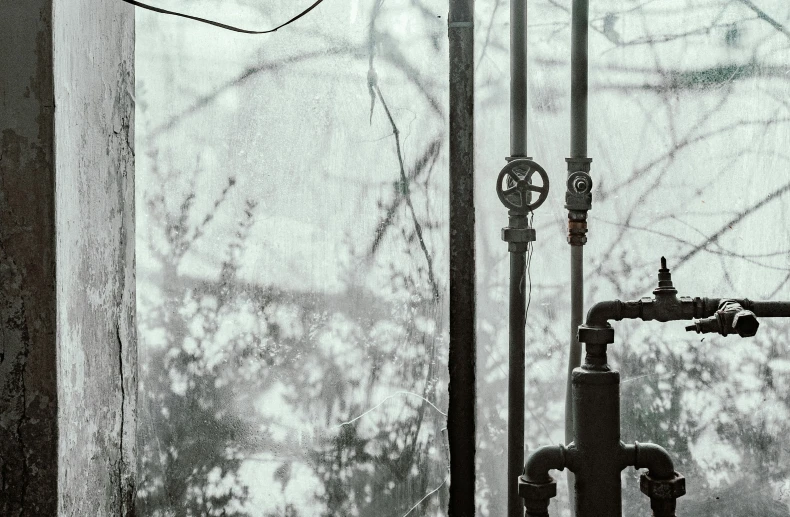 an outdoor gas water heater sitting in front of a window