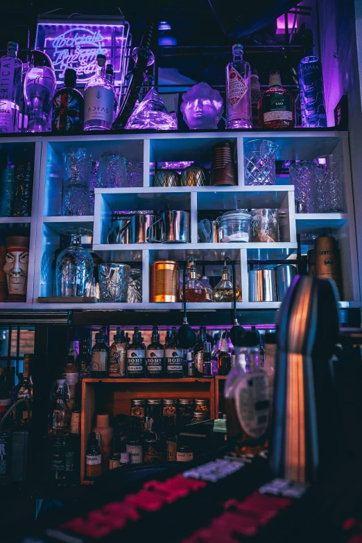 a small shelf with many glass bottles and jars