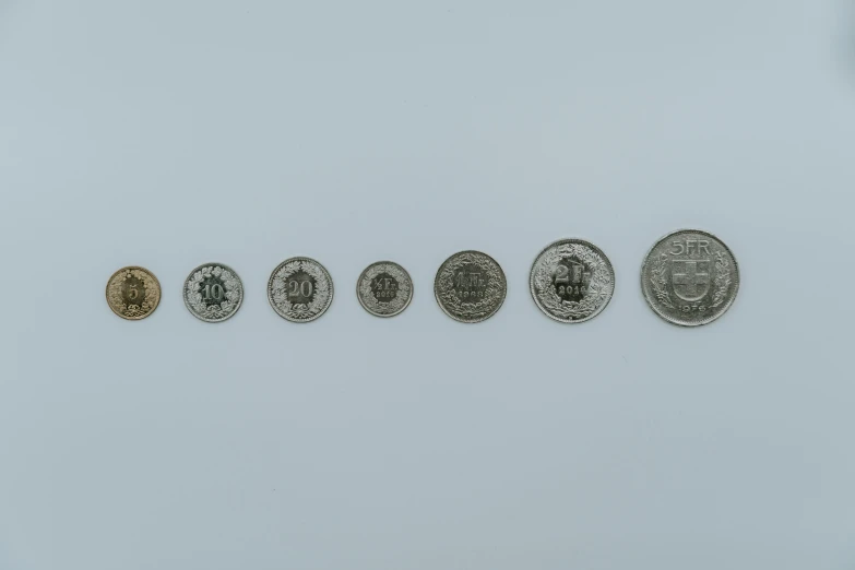 five different coins with some of the one being more expensive