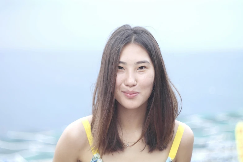 a woman is standing outdoors with a sky background