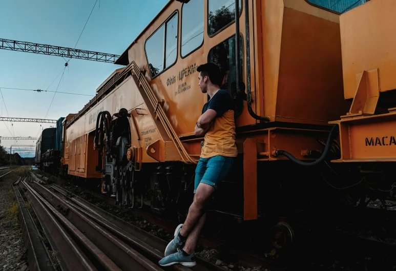 a person leaning against the side of a train
