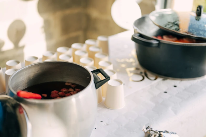 a metal pot filled with food sitting on top of a table