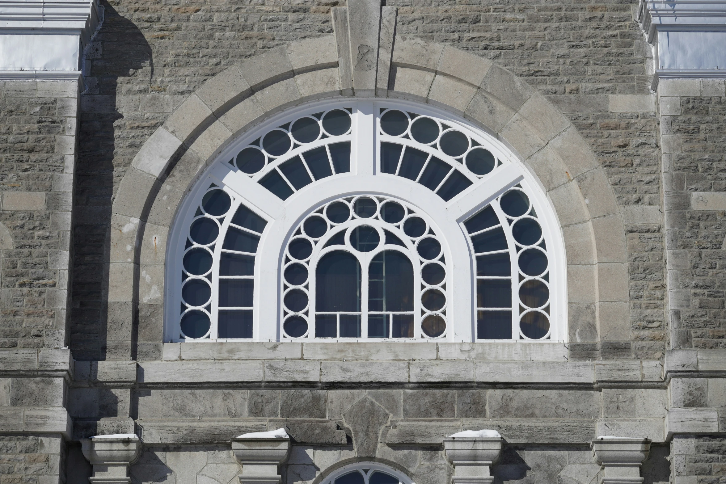 an old church with large windows and stone architecture