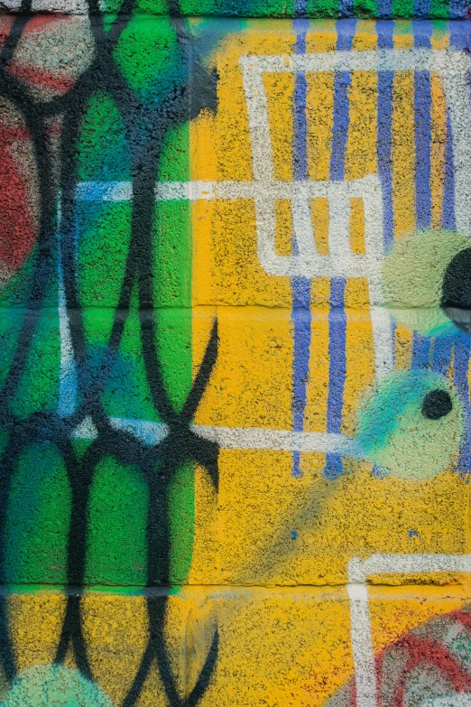 a close up of a wall with graffiti in the corner