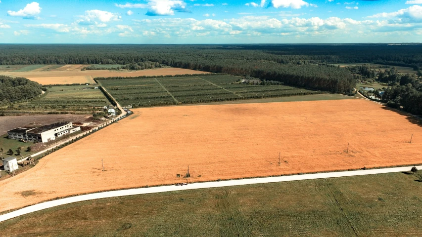 an aerial s of a farm with land for farm animals