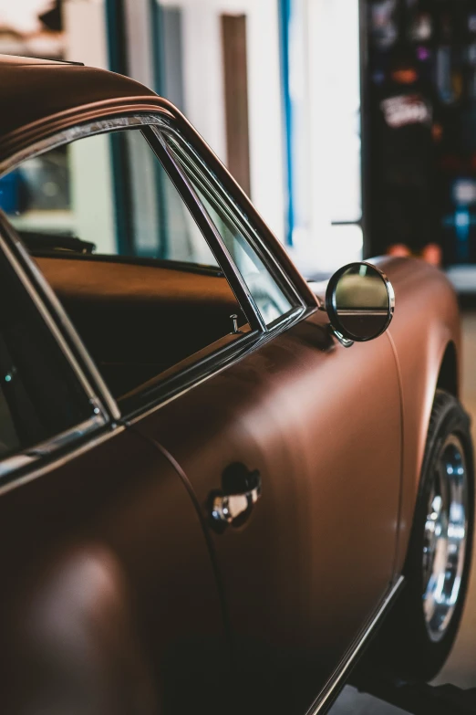 a car is seen from the side door mirror