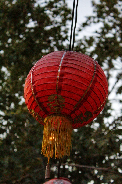 an asian lantern lit up in the sky