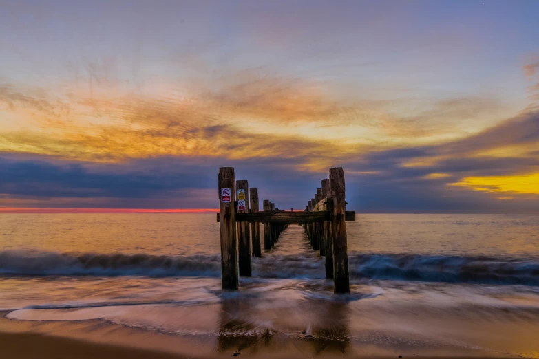 a very long pier extending out into the ocean