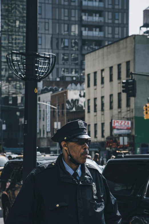 the police officer is standing in front of the street light