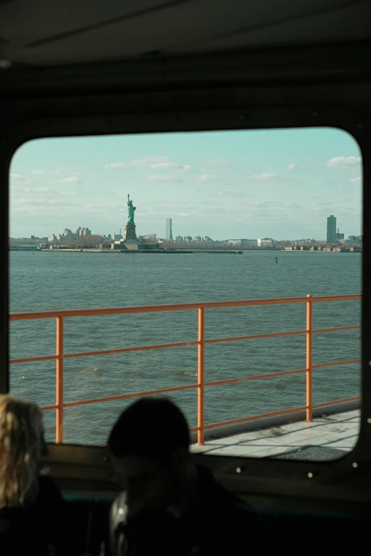 two people looking at the view from the boat in the water