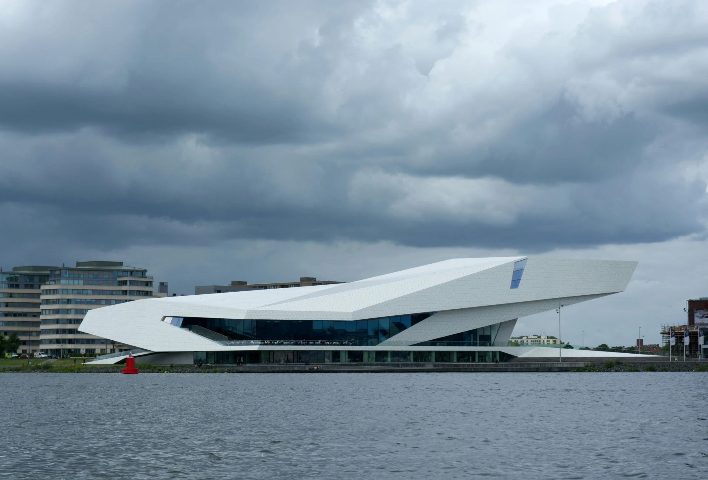 a large white structure next to a large body of water