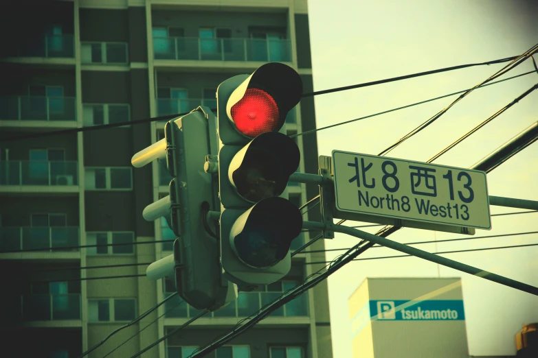 a traffic light hanging from the side of a pole