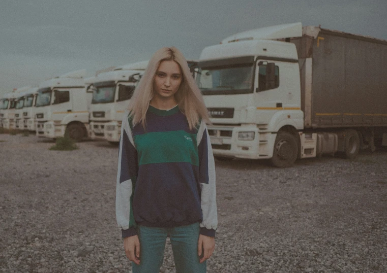 a man is standing in front of many trucks