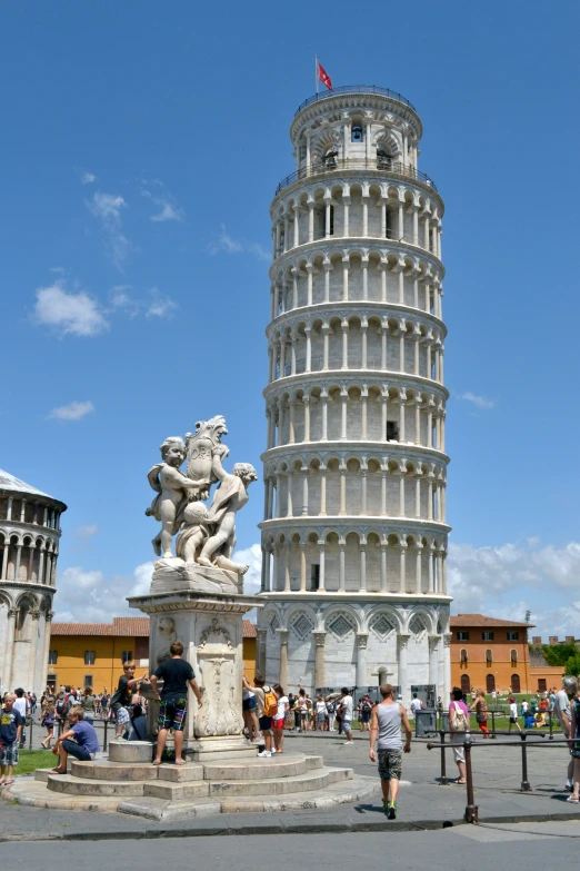 a giant tower of pisa is surrounded by tourists