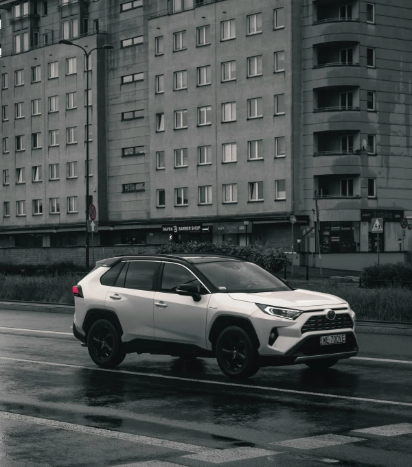 a car parked in front of a very large building