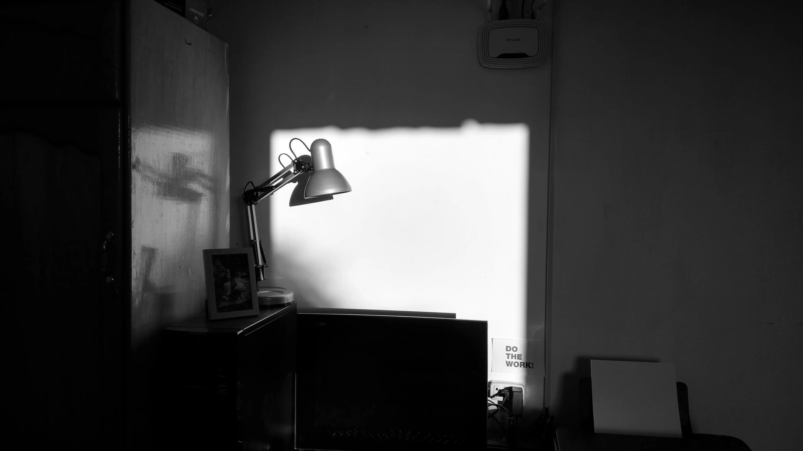 black and white po of a room with door and light