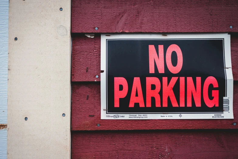 a sign attached to the side of a red building