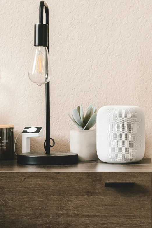 a dim dim lit lamp on top of a wooden shelf