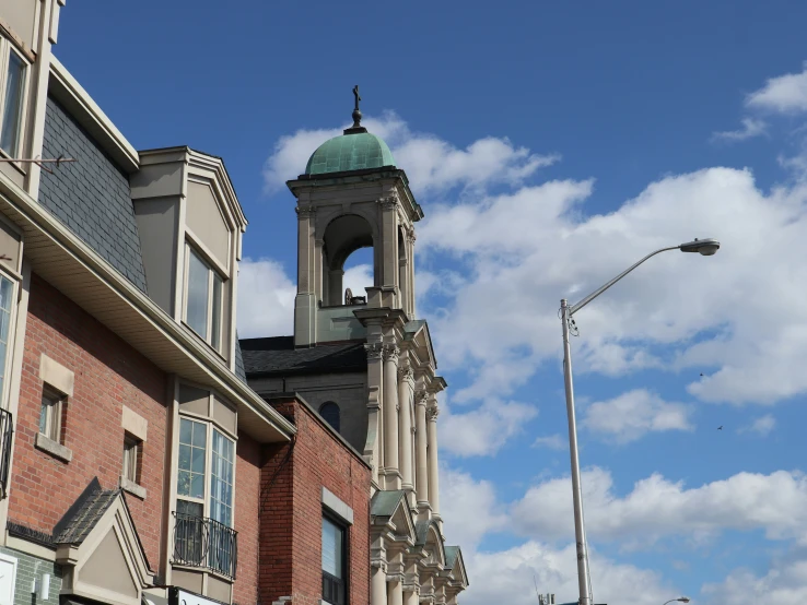 some buildings a street lights and blue sky