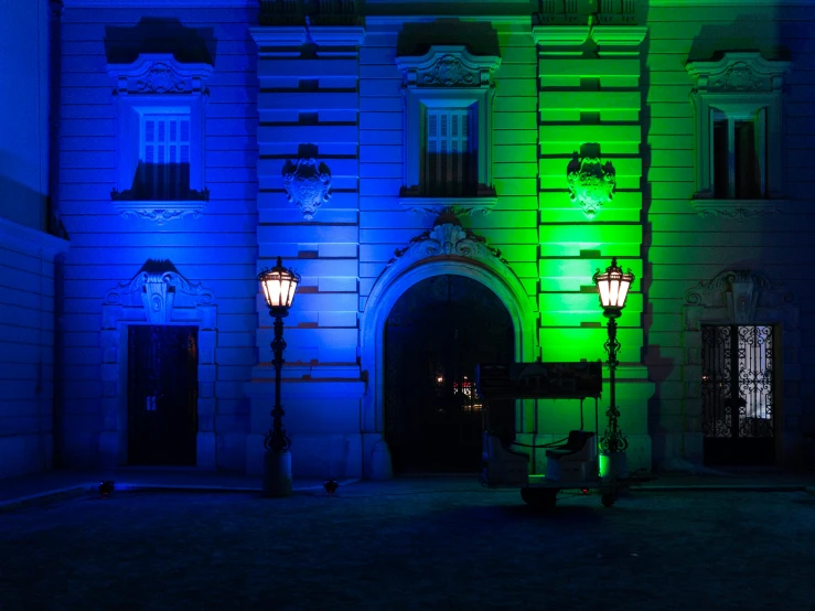 a building lit with blue lights at night