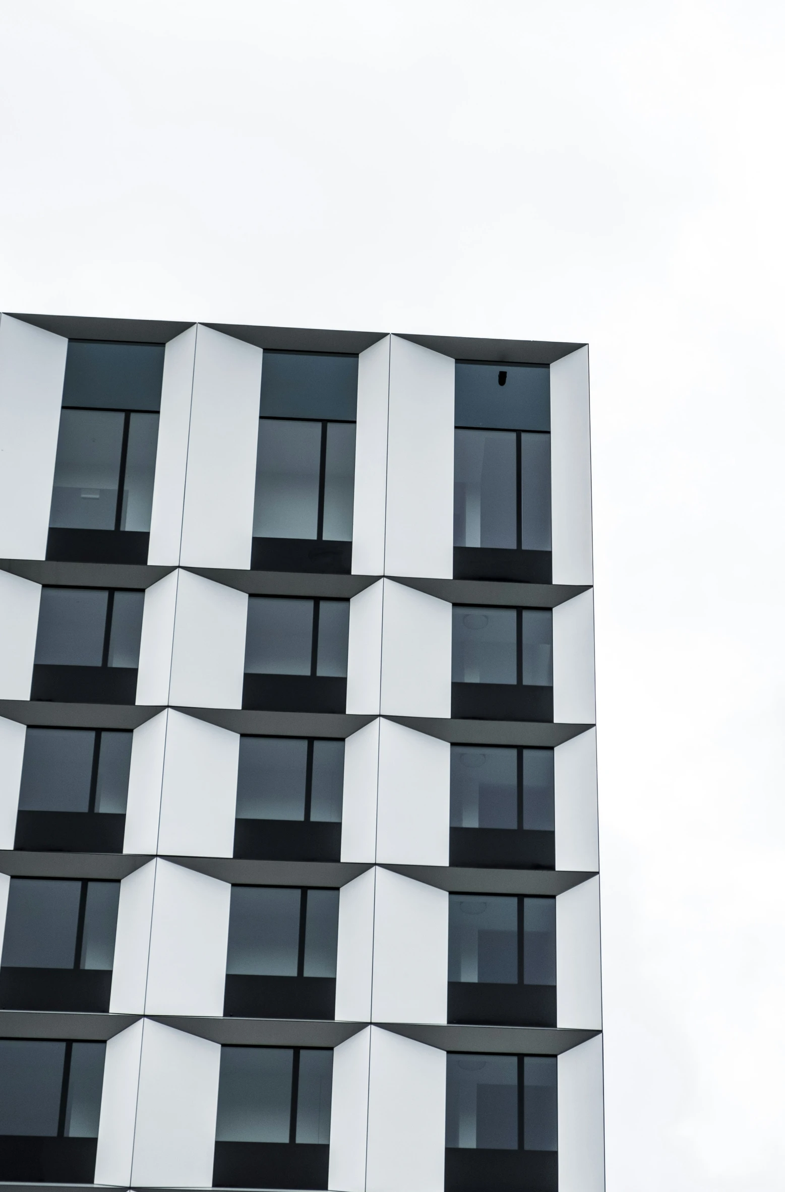 a very tall building with windows, and a clock