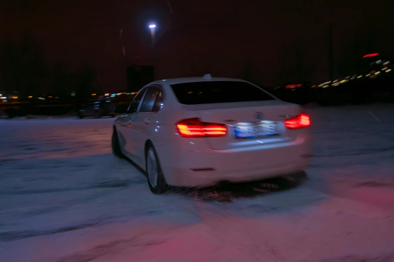 a car is parked in the snow on a street