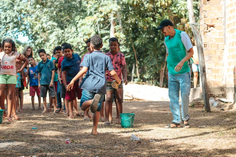 a group of people that are playing soccer in the dirt