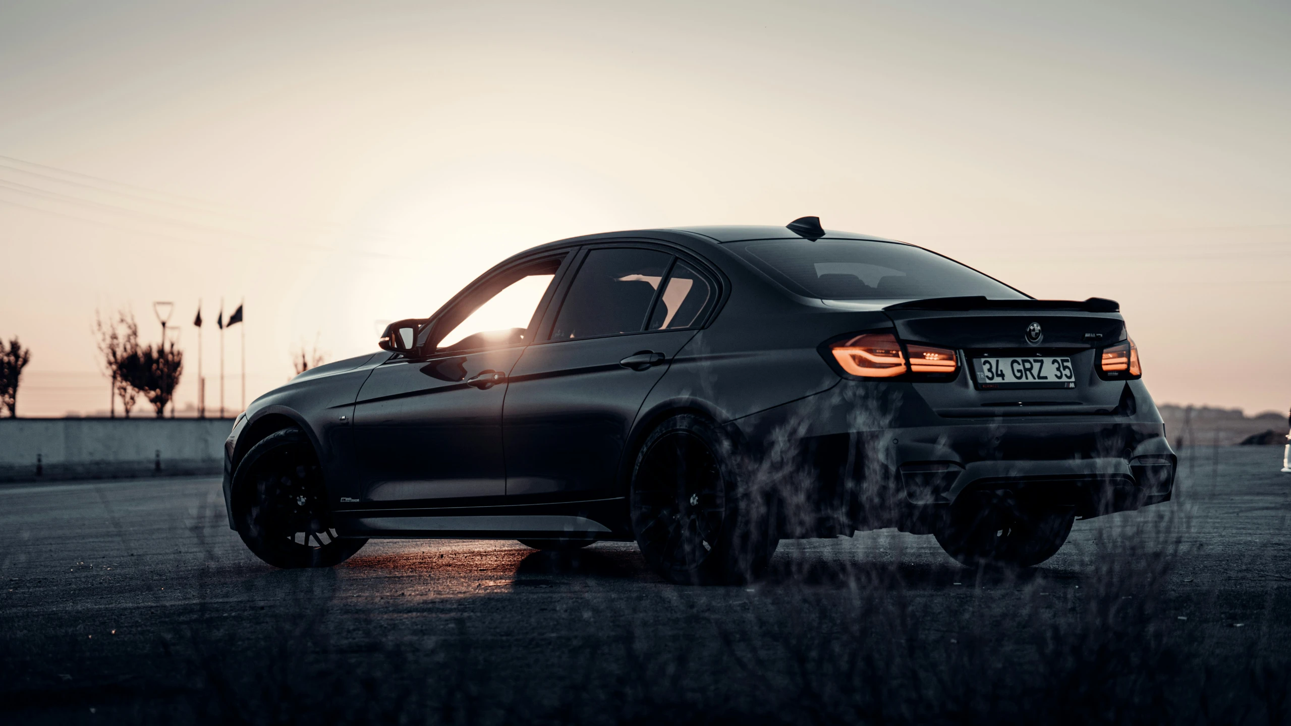 the bmw is driving on a dirt road