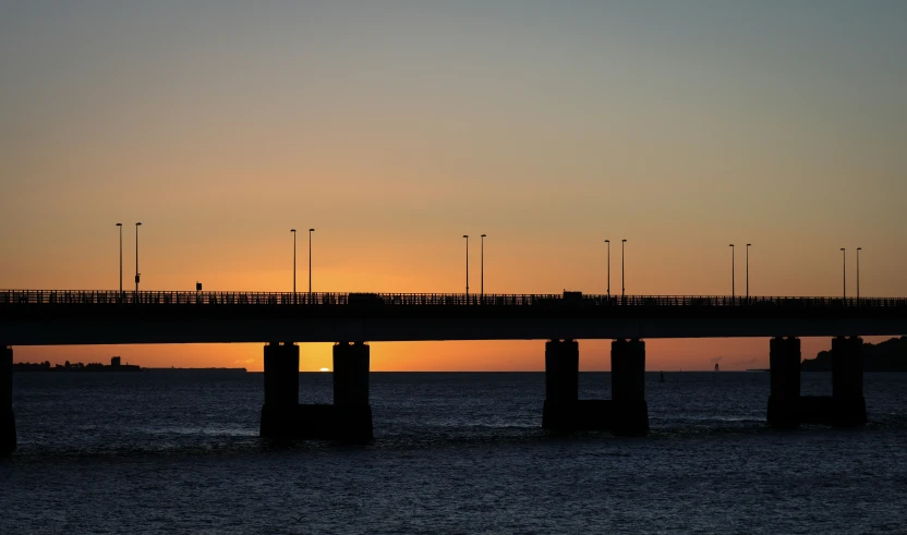 a large long bridge over water near the ocean