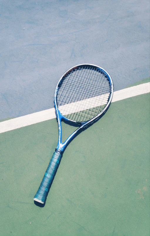 a tennis racket rests on the tennis court