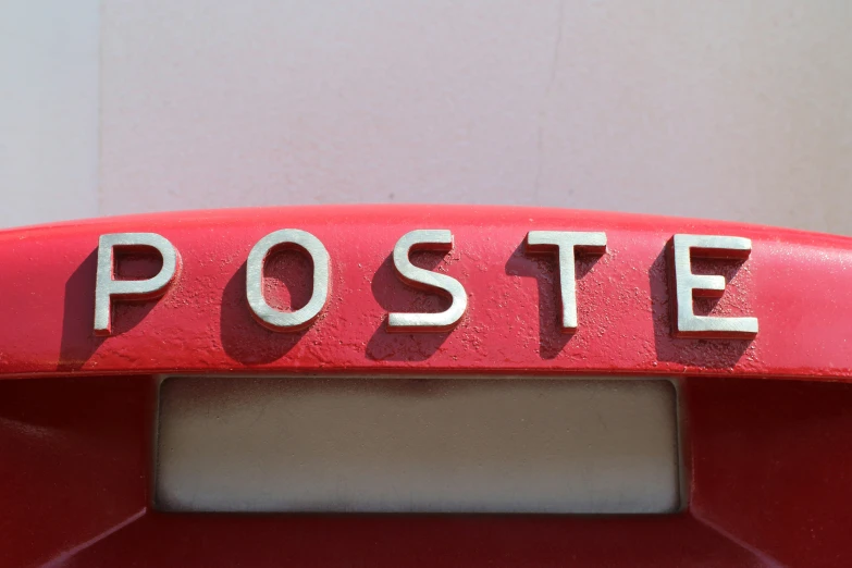 this is a red metal post with the word poste written on it