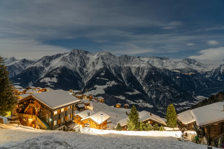 a ski slope with several snow covered houses