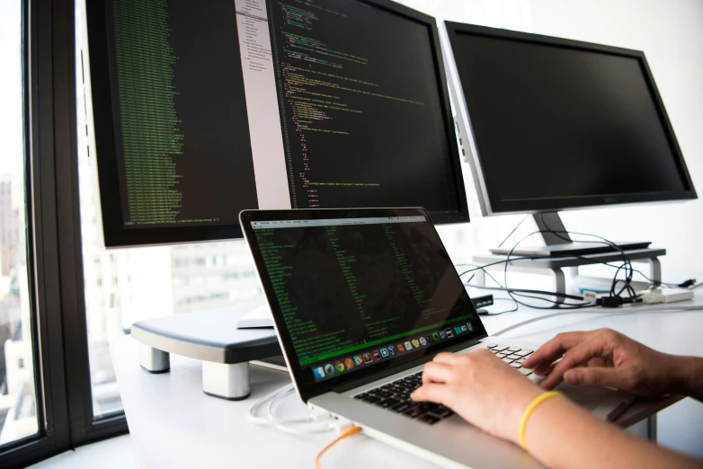 the man is typing on his computer screen