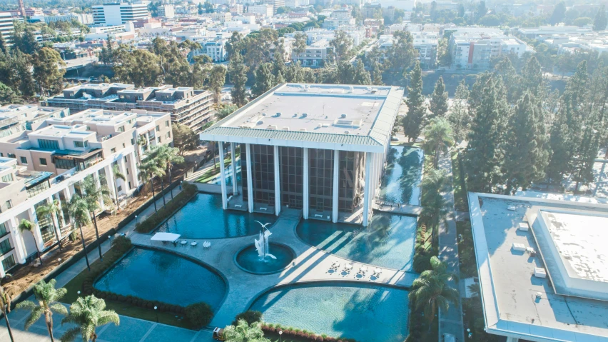 a po taken from a bird's eye view looking down at a swimming pool and surrounding buildings