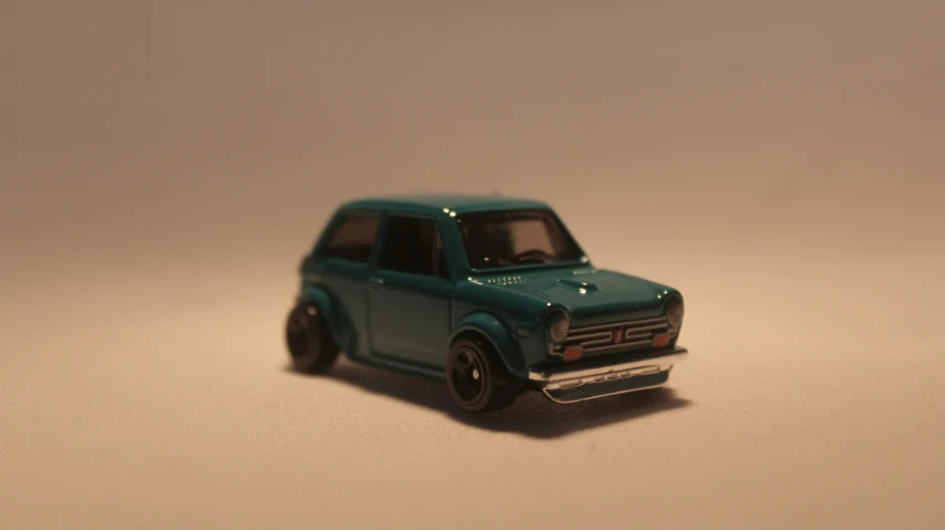 a toy model car sitting on a white surface