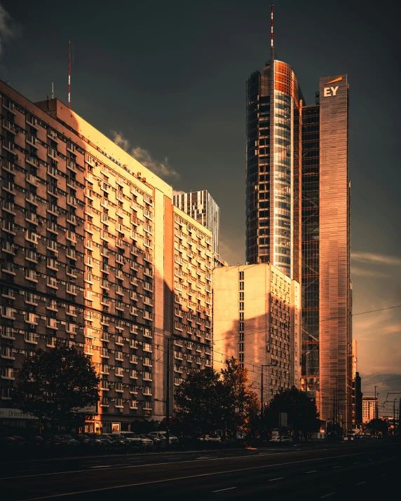 tall building towers above a city in the night