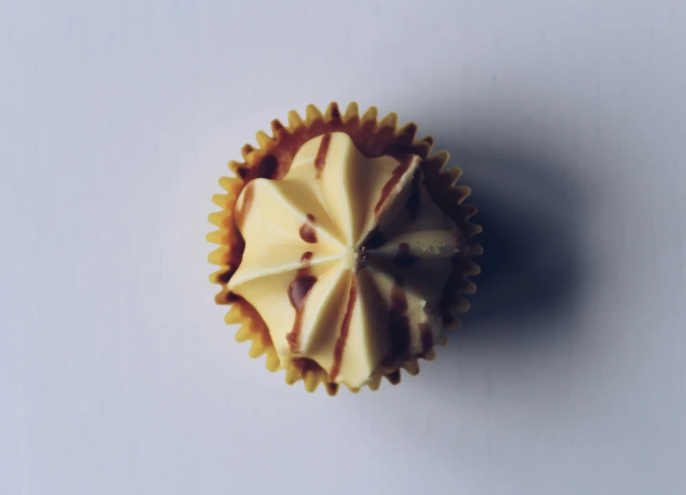 a cupcake has white and chocolate toppings